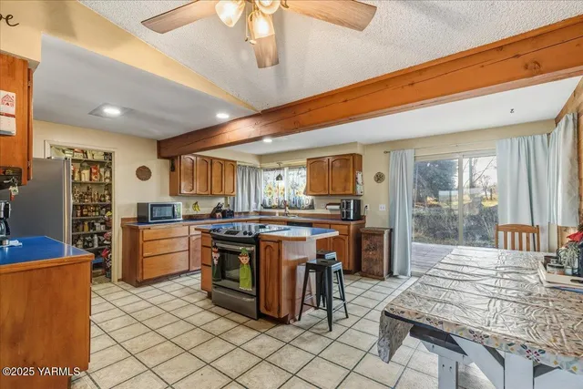 a kitchen with stainless steel appliances a stove a sink dishwasher and cabinets with wooden floor