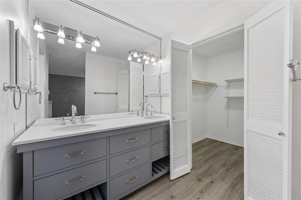 18240 Midway Road, Unit 402 Dallas, TX 75287 - Photo 15 of 29 Dual vanity with undermount sinks, stone countertop, and brushed nickel hardware