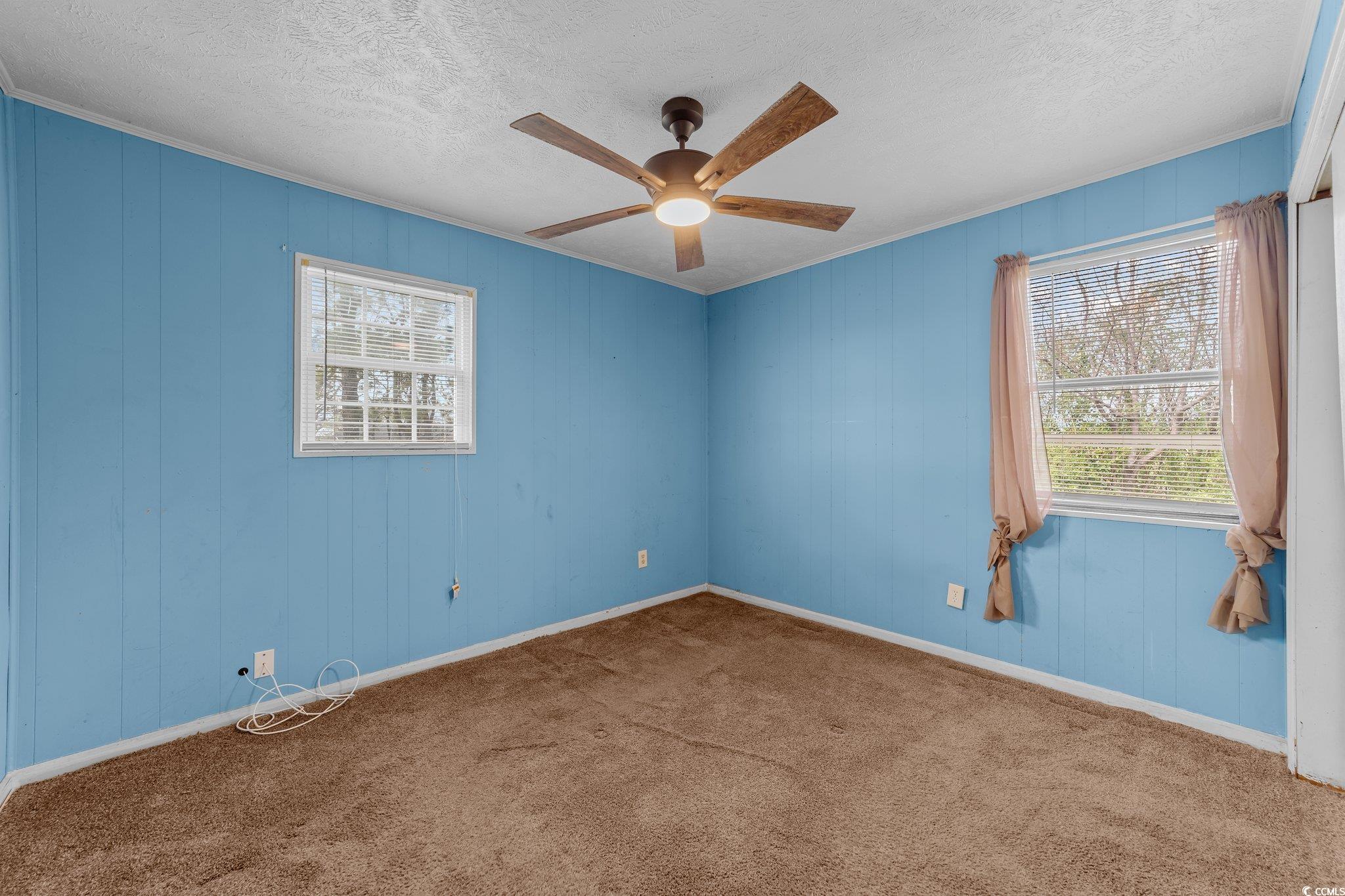2710 Gaddys Mill Road Dillon, SC 29536 - Photo 13 of 40 Carpeted spare room featuring baseboards, a textur