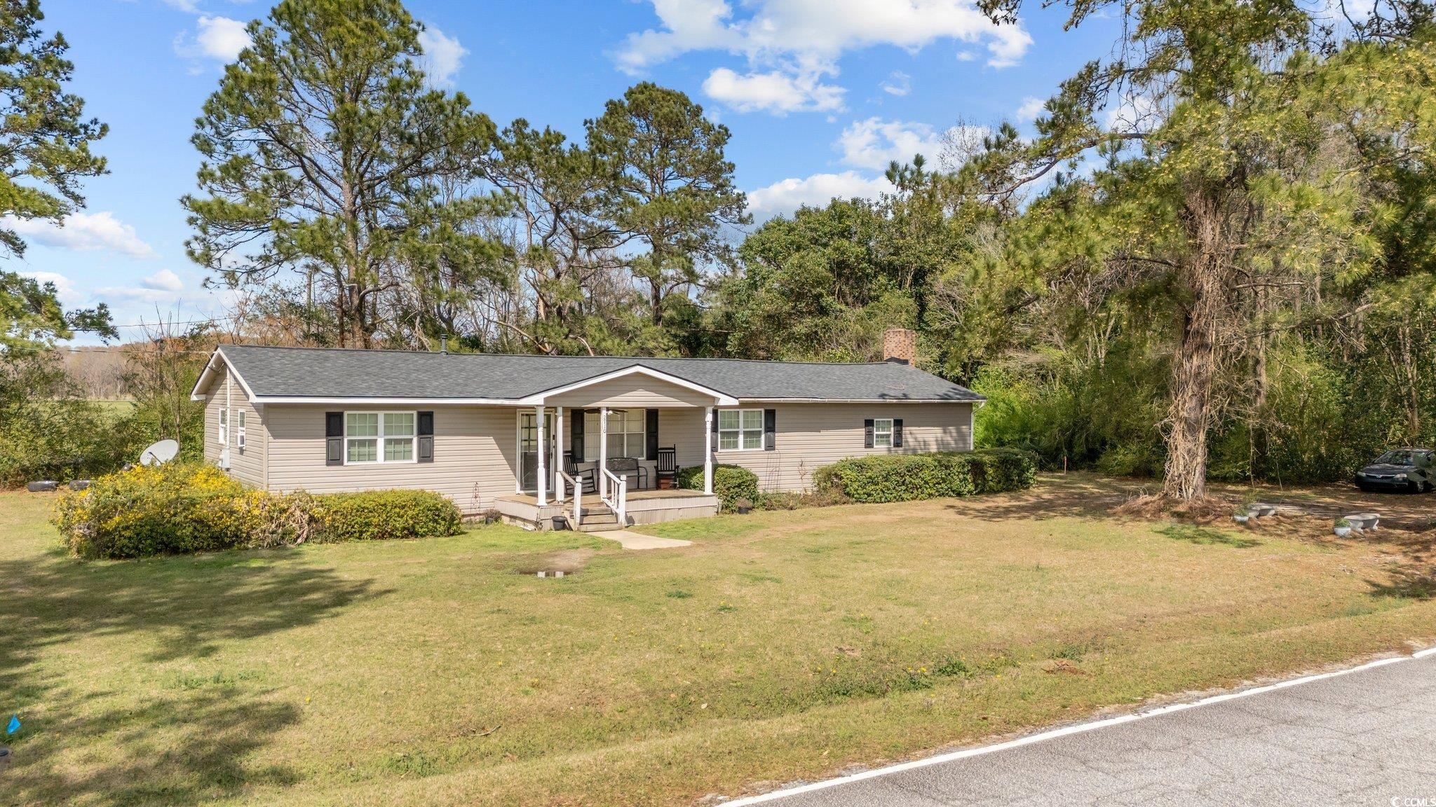 2710 Gaddys Mill Road Dillon, SC 29536 - Photo 2 of 40 Ranch-style home with covered porch, a chimney, an