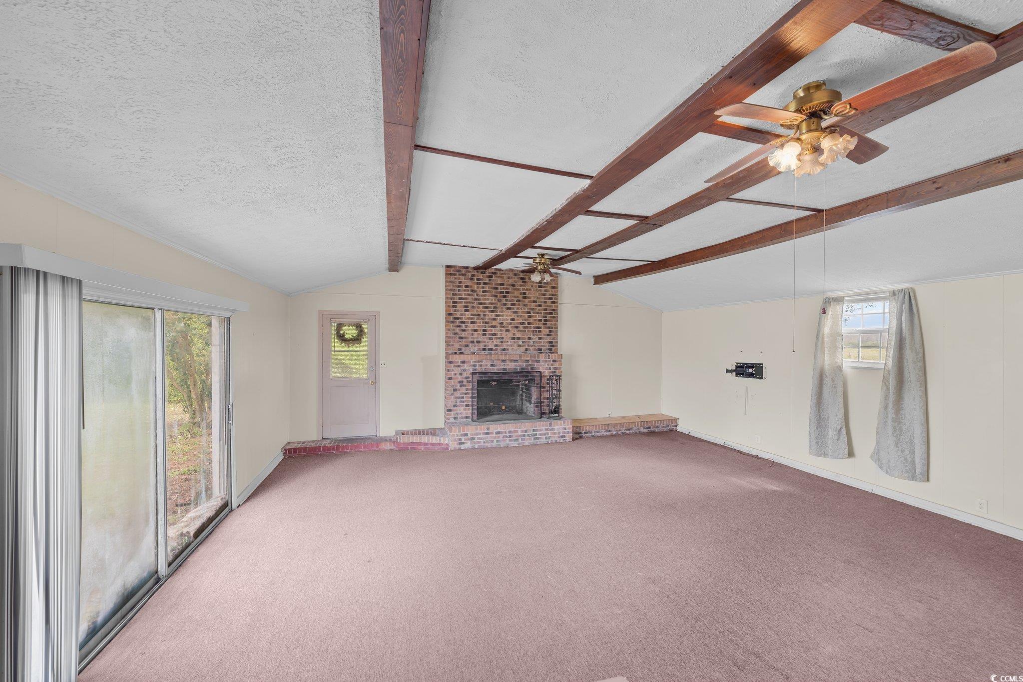 2710 Gaddys Mill Road Dillon, SC 29536 - Photo 23 of 40 Unfurnished living room with lofted ceiling with b