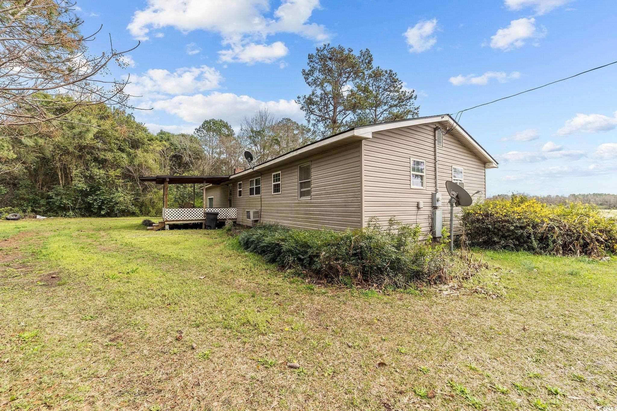 2710 Gaddys Mill Road Dillon, SC 29536 - Photo 36 of 40 View of property exterior featuring a yard and a d