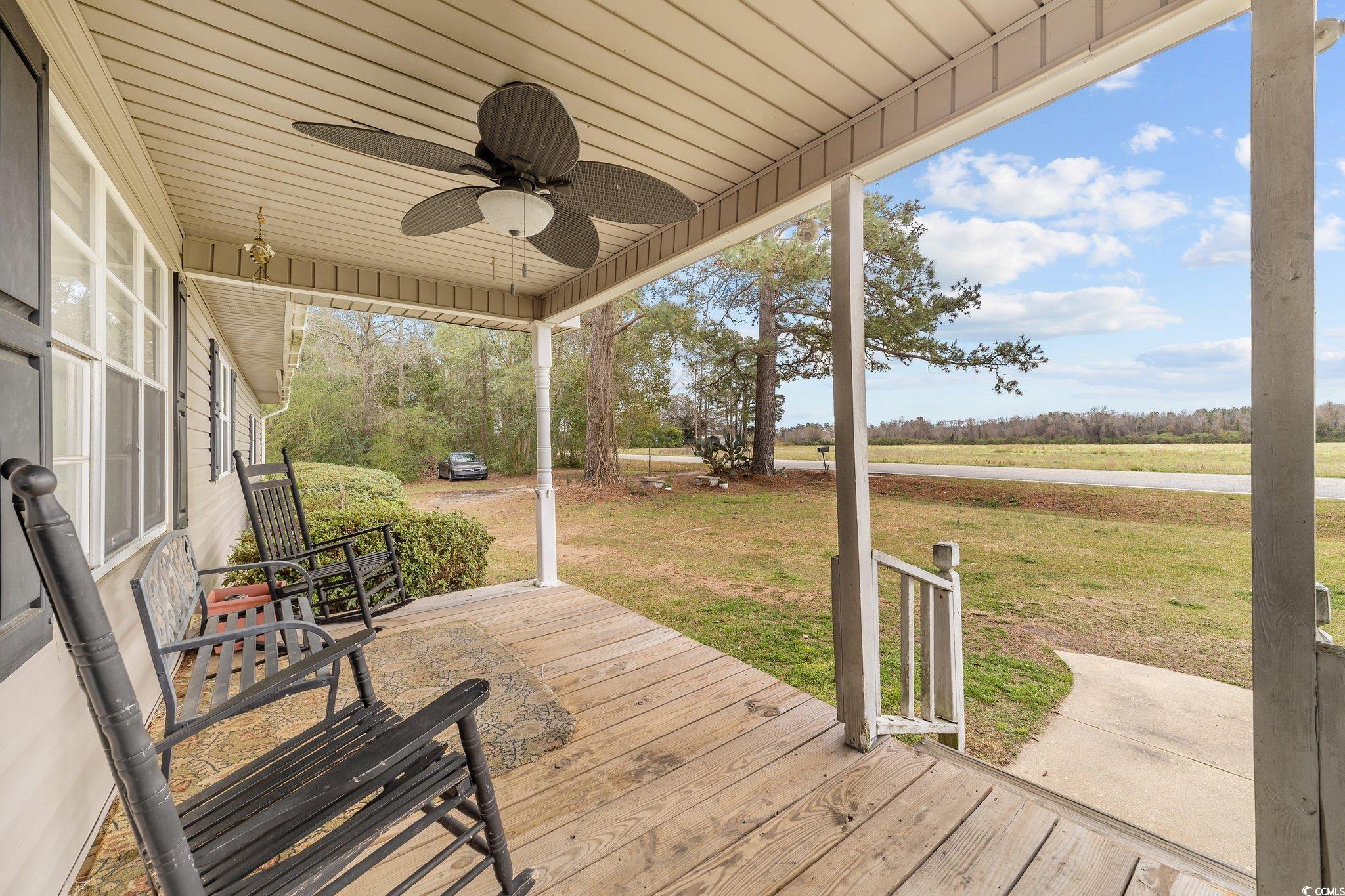 2710 Gaddys Mill Road Dillon, SC 29536 - Photo 5 of 40 Wooden deck with a lawn and ceiling fan