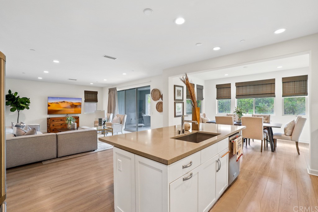 279 Barnes Road Tustin, CA 92782 - Photo 11 of 32 a large living room with stainless steel appliances granite countertop a couch and a wooden floor