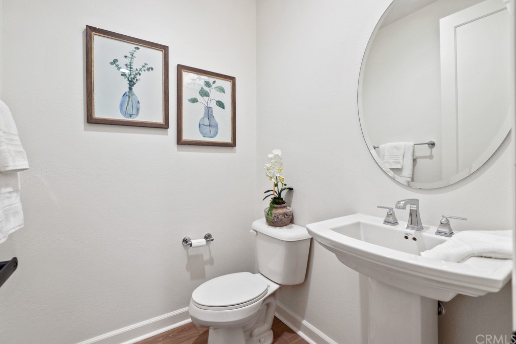 279 Barnes Road Tustin, CA 92782 - Photo 15 of 32 a bathroom with a toilet a sink and a mirror