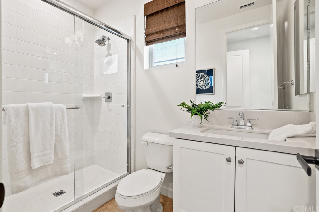 279 Barnes Road Tustin, CA 92782 - Photo 17 of 32 a bathroom with a shower sink vanity mirror and toilet