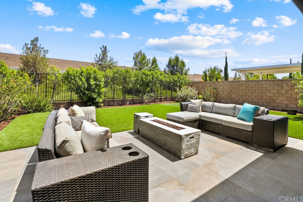 279 Barnes Road Tustin, CA 92782 - Photo 24 of 32 a view of a patio with couches and a table and chairs with wooden fence