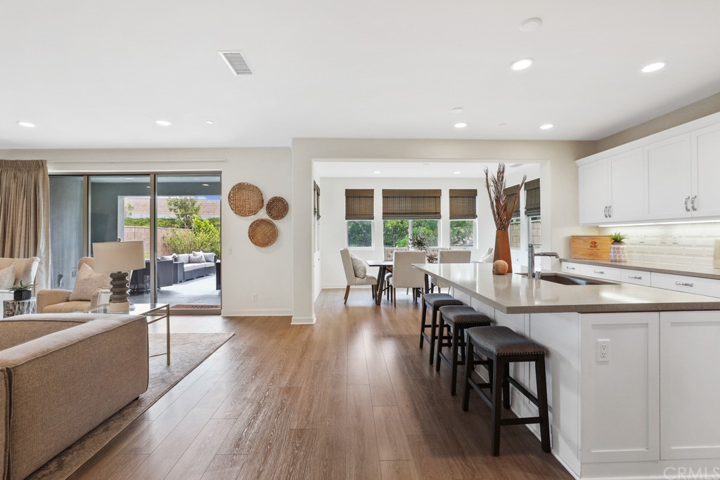 279 Barnes Road Tustin, CA 92782 - Photo 4 of 32 a living room with stainless steel appliances kitchen island granite countertop furniture and a wooden floor