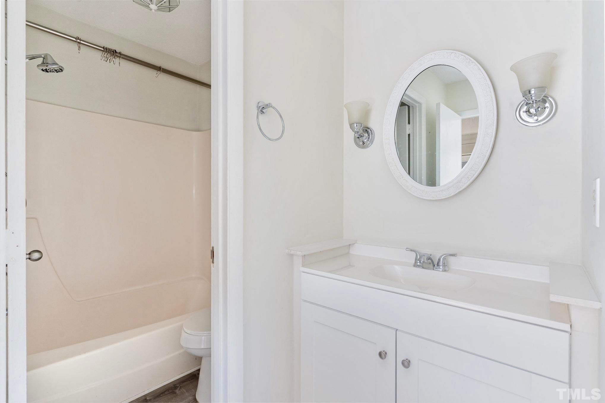 5073 Tall Pines Court Raleigh, NC 27609 - Photo 12 of 21 a bathroom with a sink and a mirror