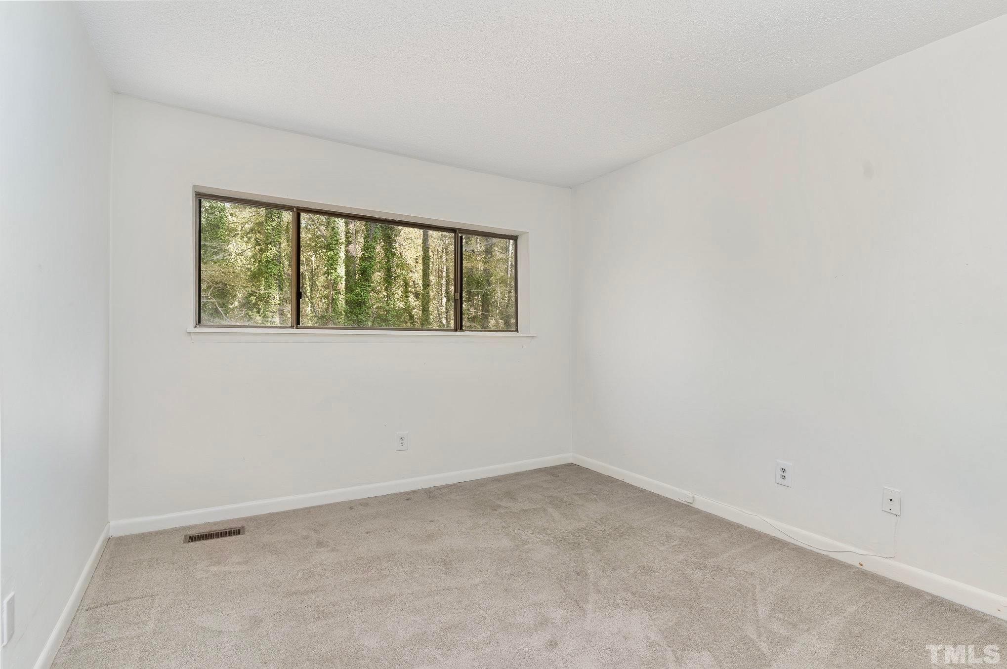 5073 Tall Pines Court Raleigh, NC 27609 - Photo 13 of 21 an empty room with a window