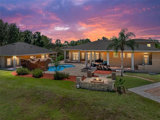 a view of a house with backyard sitting area and garden
