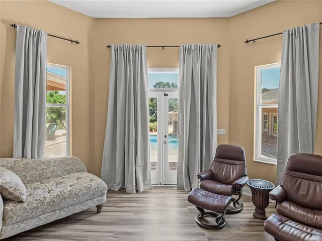 a bedroom with a bed and a flat tv screen on dresser