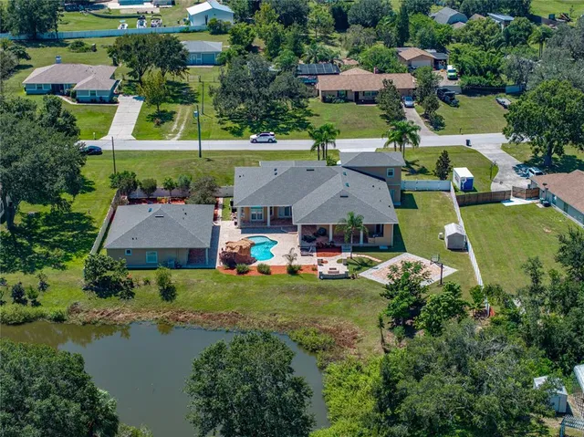 an aerial view of a house with garden space and lake view