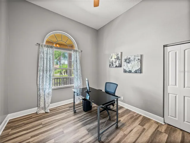 a view of empty room with wooden floor