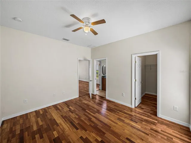 an aerial view of a house with a yard and a large tree