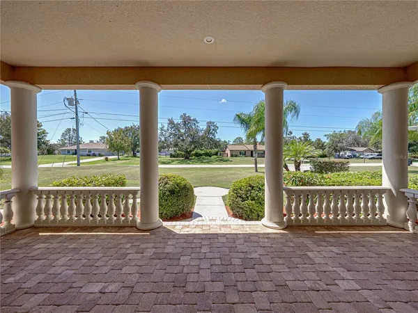 a view of a porch with a floor to ceiling window chair and yard