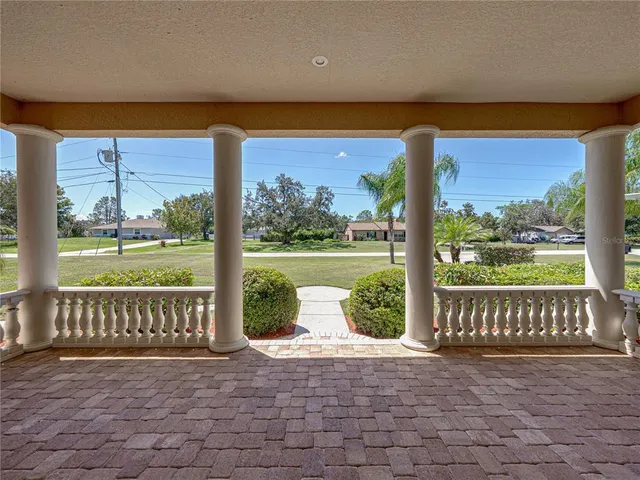 a view of a porch with a floor to ceiling window chair and yard