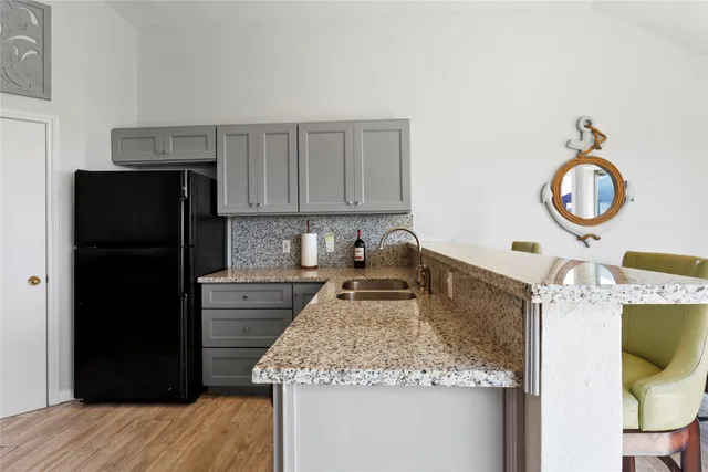 a kitchen with a refrigerator and a sink