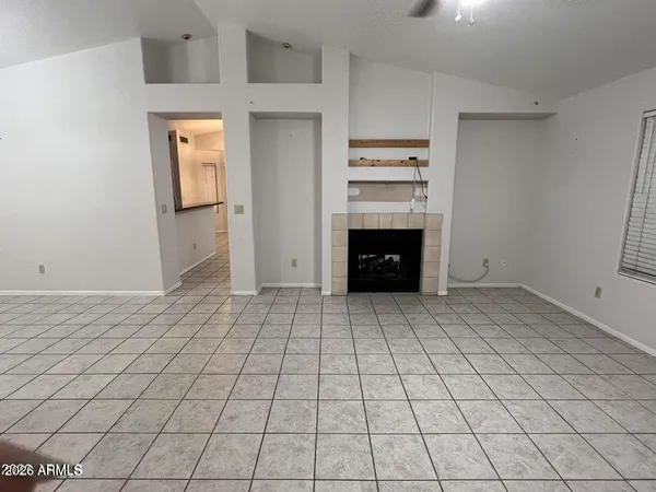 a view of an empty room with a fireplace