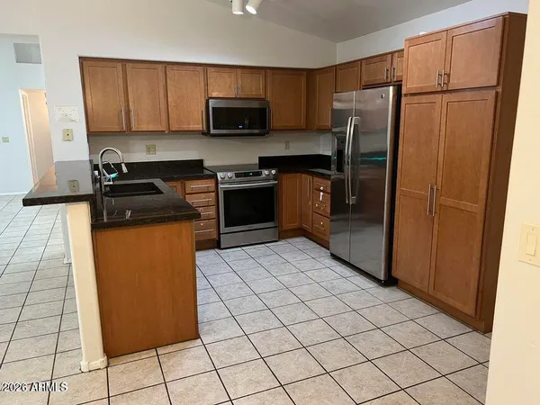 a kitchen with a refrigerator a stove a microwave and cabinets