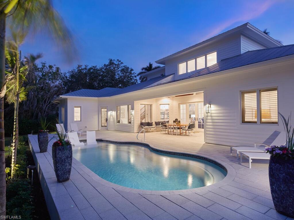 375 Wedge Drive Naples, FL 34103 - Photo 2 of 3 a view of a house with swimming pool and sitting area