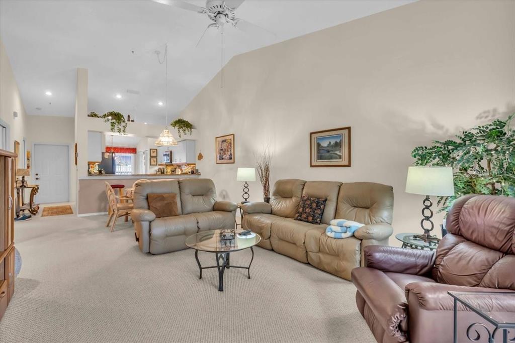 6713 Stone River Road, Unit 206 Bradenton, FL 34203 - Photo 11 of 58 a living room with furniture and a large window