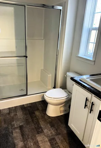 a bathroom with a toilet and a shower