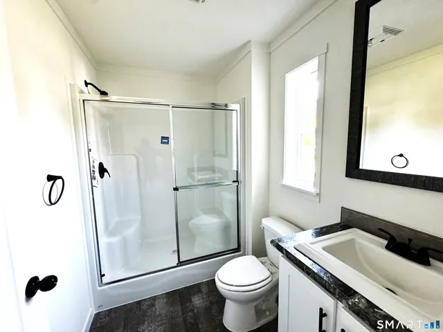 a bathroom with a sink toilet and shower