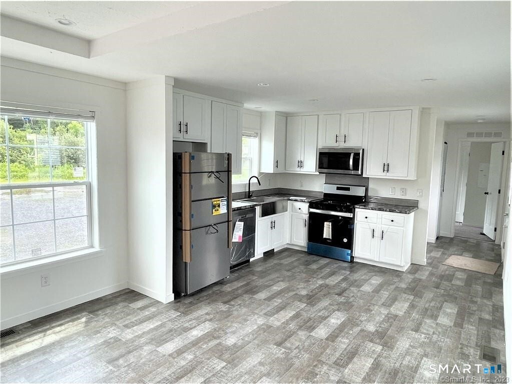 301 South Main Street Newtown, CT 06470 - Photo 2 of 17 a kitchen with white cabinets and refrigerator