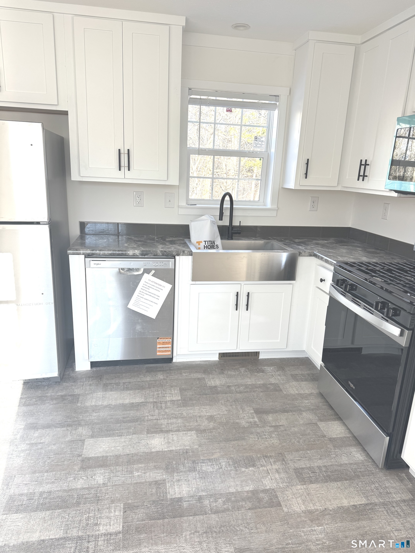 301 South Main Street Newtown, CT 06470 - Photo 4 of 17 a kitchen with granite countertop white cabinets and white appliances