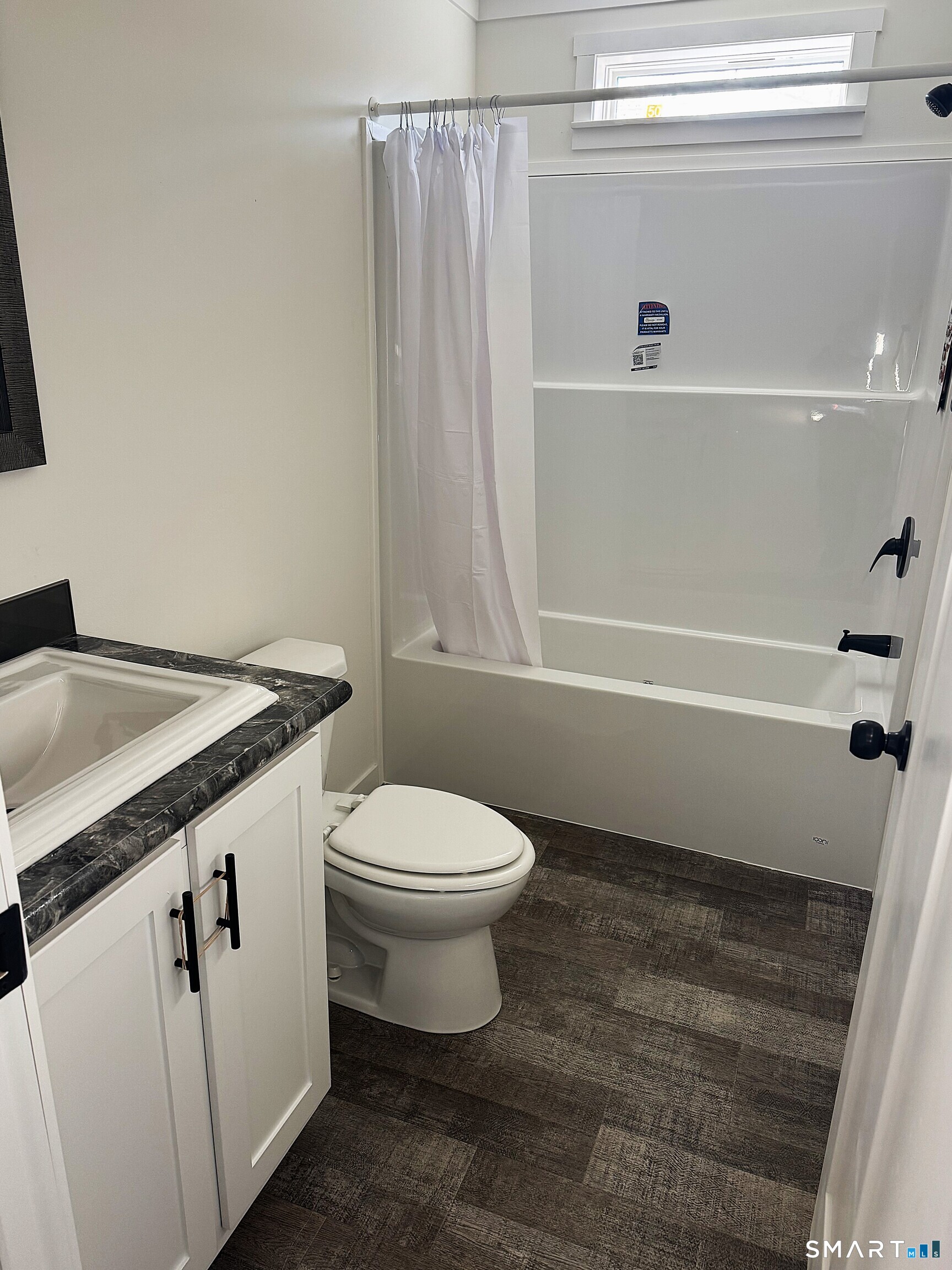 301 South Main Street Newtown, CT 06470 - Photo 10 of 17 a bathroom with a toilet a sink and bathtub