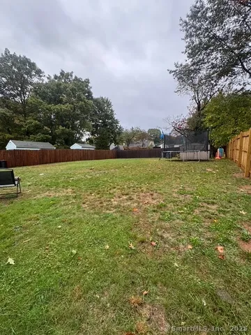 a large yard with lots of green space and fog