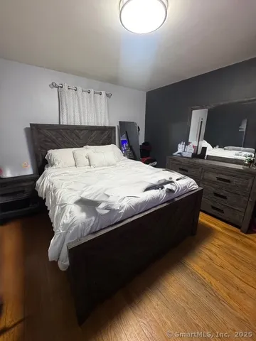 a bed sitting in a bedroom next to a window