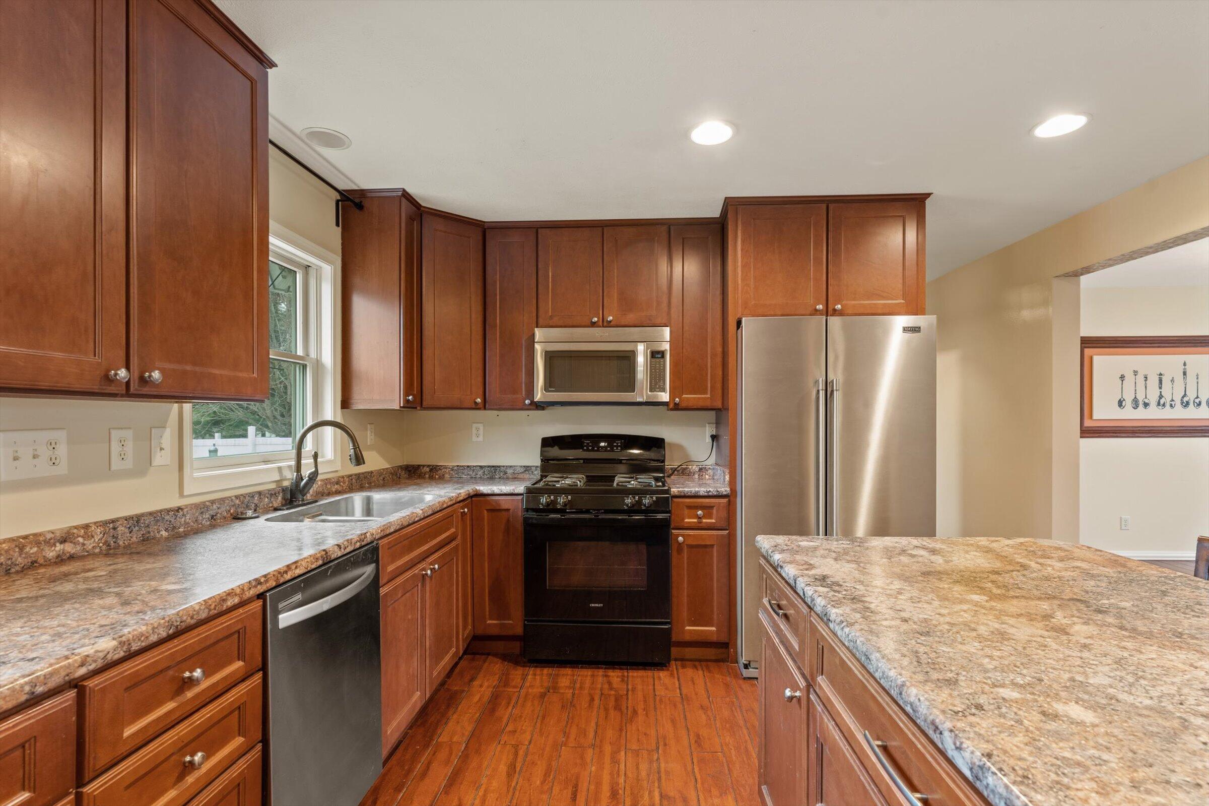 7692 North Emery Road Rolling Prairie, IN 46371 - Photo 17 of 69 a kitchen with a sink stove and refrigerator