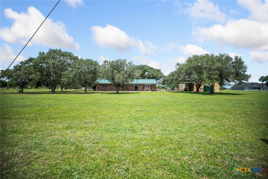 181 Pecan Street Port Lavaca, TX 77979 - Photo 27 of 34 a view of a grassy field with trees in the background