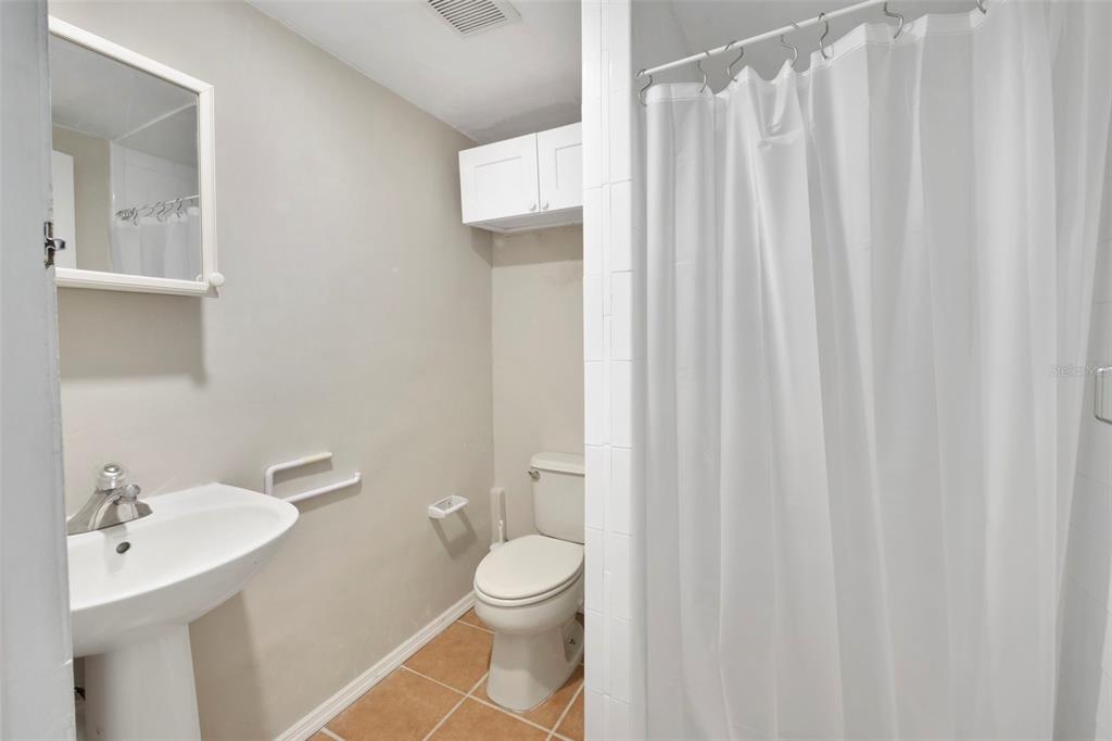 2331 West Oak Street Kissimmee, FL 34741 - Photo 12 of 34 a bathroom with a toilet a sink and a shower