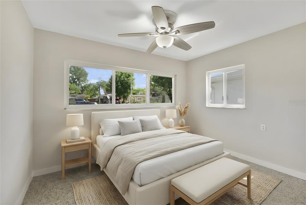 2331 West Oak Street Kissimmee, FL 34741 - Photo 13 of 34 a bedroom with a large bed and a chandelier