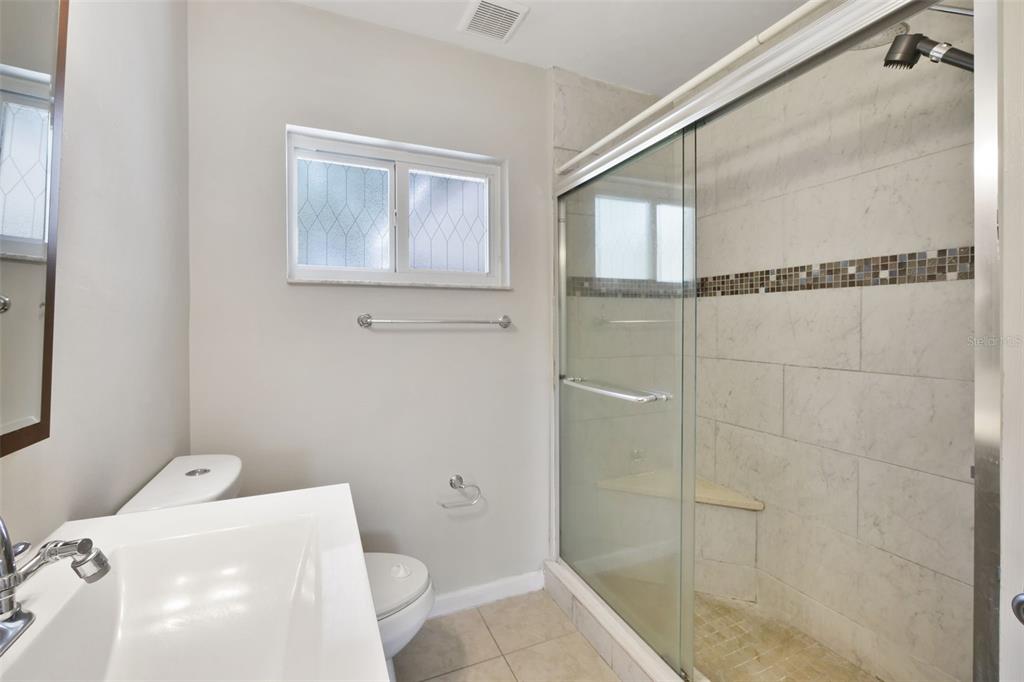 2331 West Oak Street Kissimmee, FL 34741 - Photo 16 of 34 a bathroom with a bathtub and shower