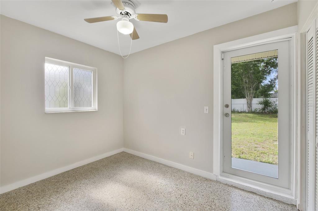 2331 West Oak Street Kissimmee, FL 34741 - Photo 17 of 34 an empty room with a window and a fan