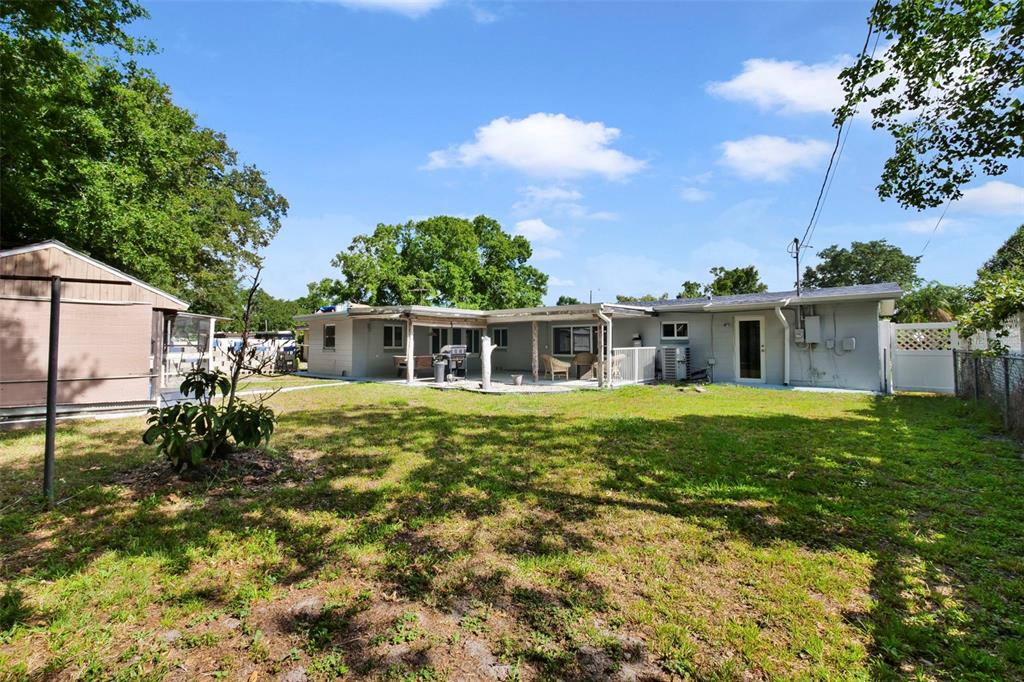 2331 West Oak Street Kissimmee, FL 34741 - Photo 24 of 34 a backyard of a house with a garden and barbeque oven