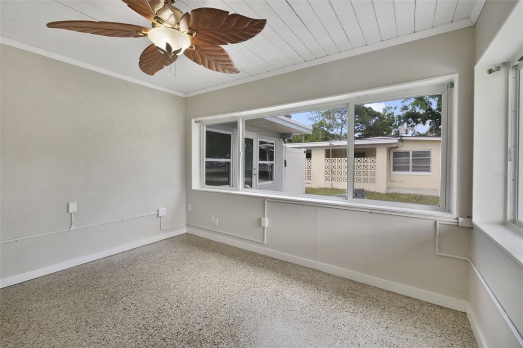 2331 West Oak Street Kissimmee, FL 34741 - Photo 33 of 34 an empty room with windows and ceiling fan