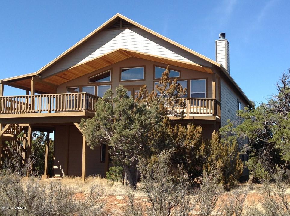 2972 Lodgepole Road Overgaard, AZ 85933 - Photo 1 of 41 a front view of a house with garden