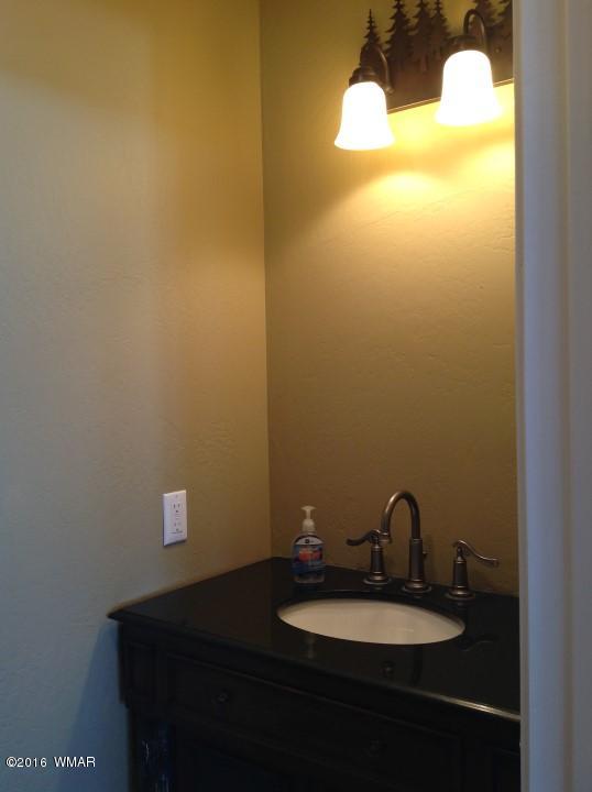 2972 Lodgepole Road Overgaard, AZ 85933 - Photo 23 of 41 a bathroom with a sink and a mirror