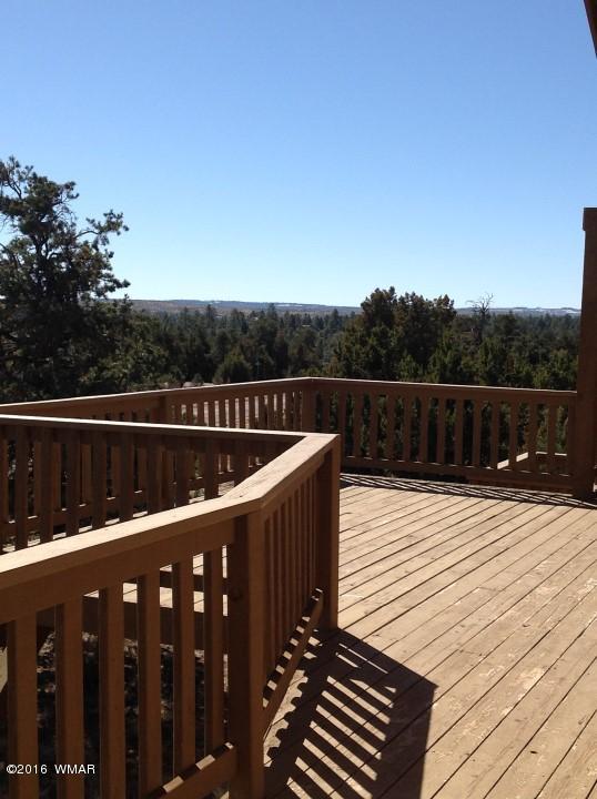 2972 Lodgepole Road Overgaard, AZ 85933 - Photo 27 of 41 a view of deck with wooden floor and fence next to a yard