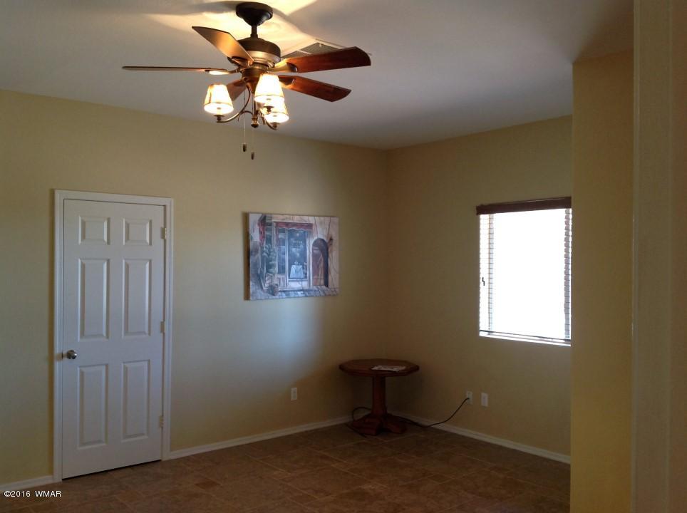 2972 Lodgepole Road Overgaard, AZ 85933 - Photo 29 of 41 a room with window and a chandelier fan