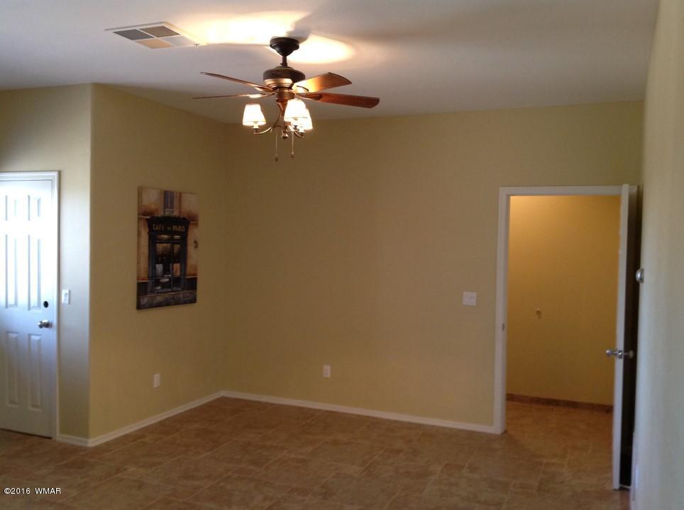 2972 Lodgepole Road Overgaard, AZ 85933 - Photo 30 of 41 en empty room with a chandelier fan