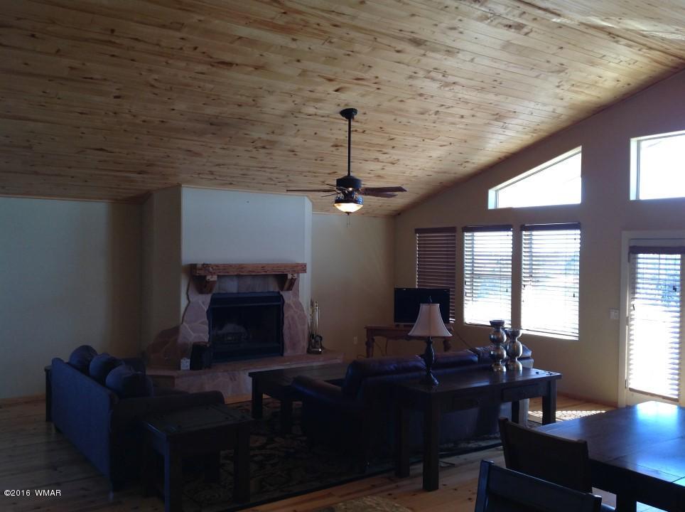 2972 Lodgepole Road Overgaard, AZ 85933 - Photo 3 of 41 a living room with furniture and a fireplace