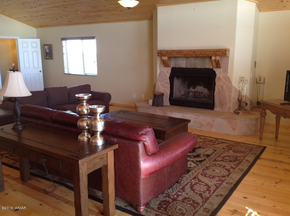 2972 Lodgepole Road Overgaard, AZ 85933 - Photo 6 of 41 a living room with furniture and a fireplace