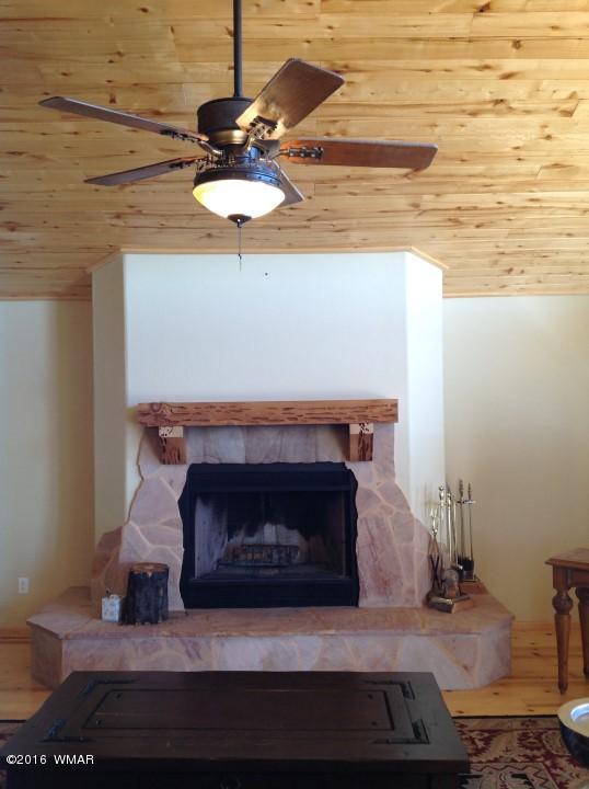 2972 Lodgepole Road Overgaard, AZ 85933 - Photo 7 of 41 a fireplace with a mirror