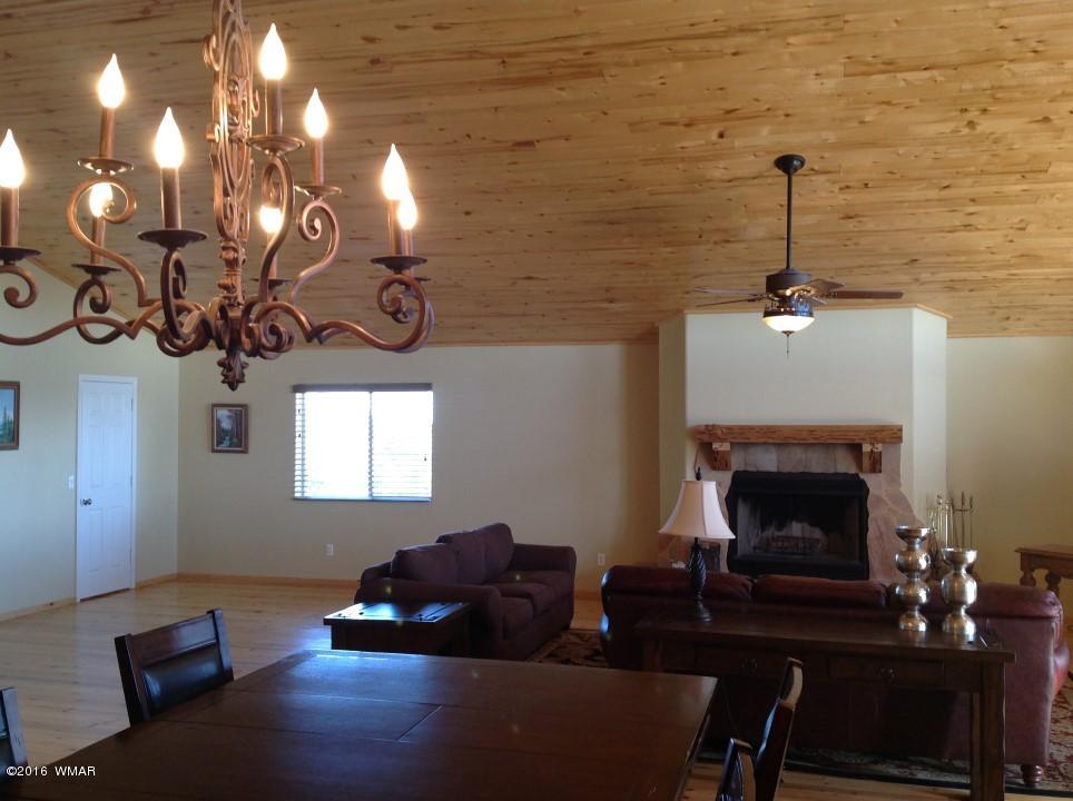 2972 Lodgepole Road Overgaard, AZ 85933 - Photo 8 of 41 a living room with furniture and a fireplace